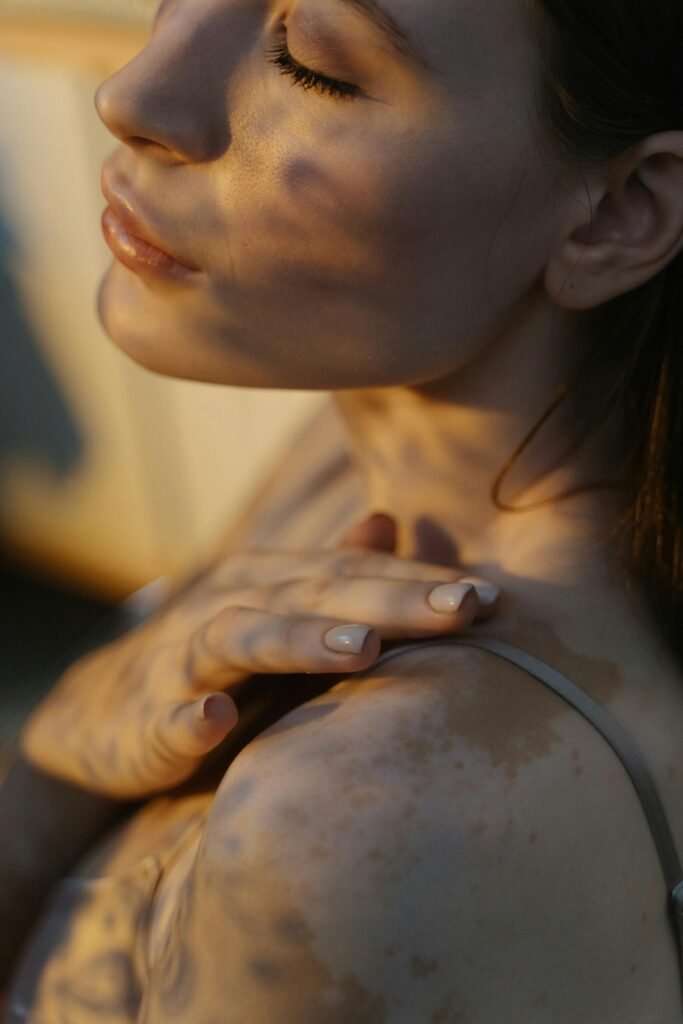 Close-up portrait showcasing the natural beauty and diversity of skin with vitiligo in warm, artistic light.